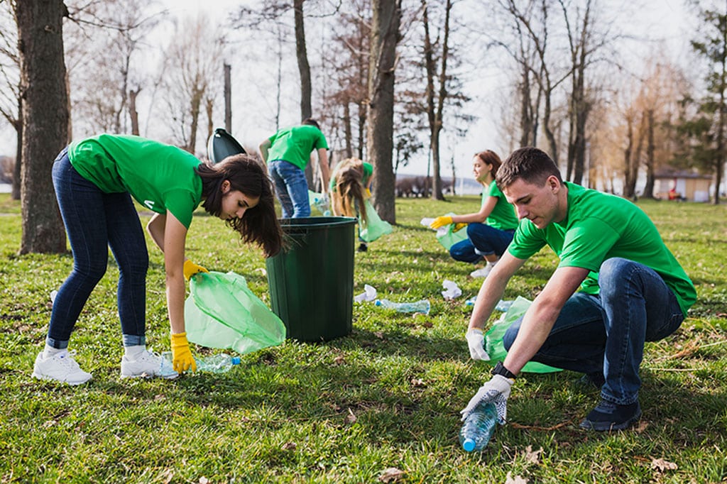 people picking up rubbish at public area