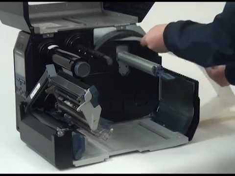A Sato thermal printer being cleaned
