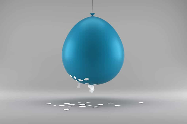 A balloon attracting paper through electrostatic interaction