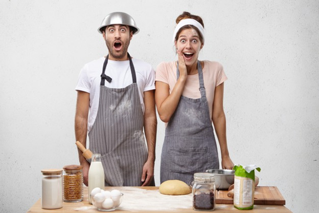 A couple cooking together in the kitchen