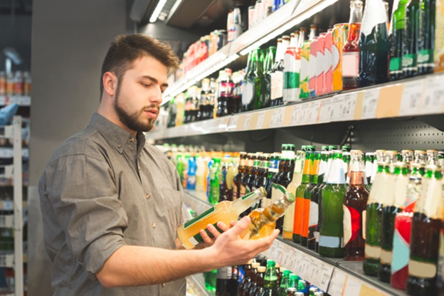 A customer is looking at beer labels