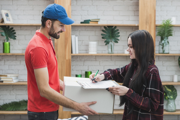 A woman signing for package delivery