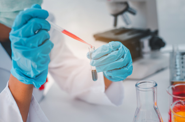 A researcher mixing chemicals in the lab