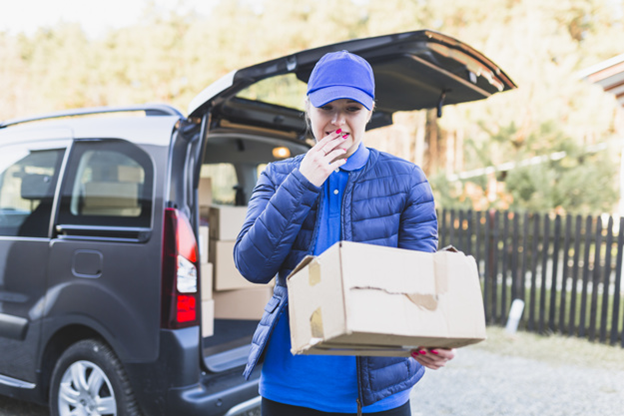 A delivery woman handling a damaged package