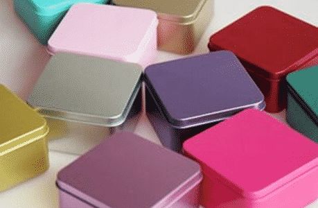 Colored tin candy boxes and canisters