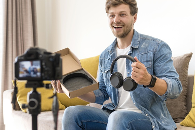 A man talks about a pair of headphones in his unboxing video