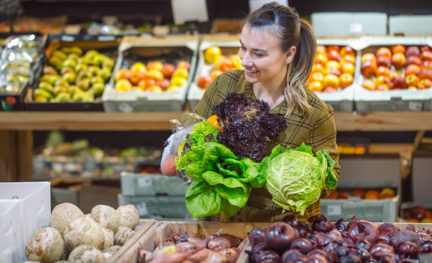 A woman holding perishables in a store