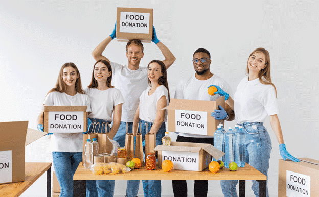 smiley-volunteers-posing-together-with-donation-boxes